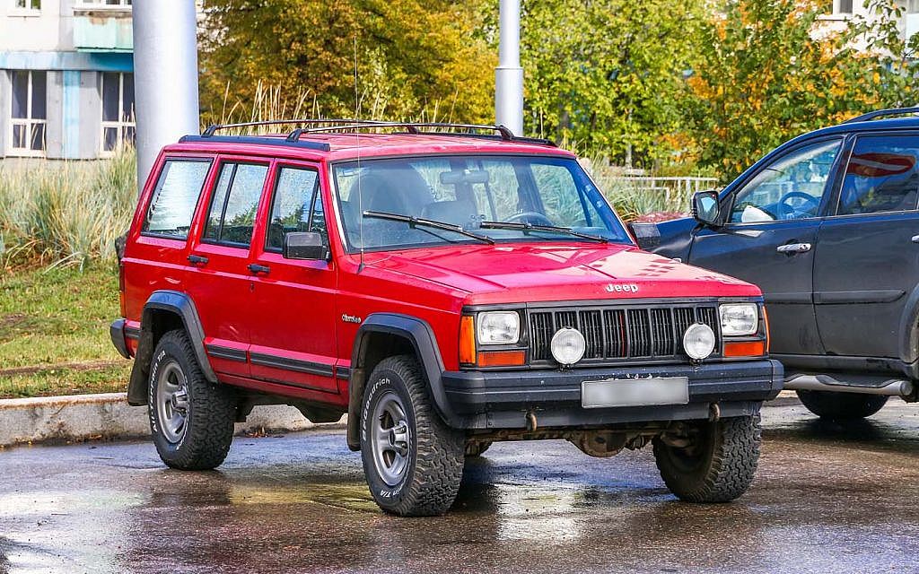 red and old Jeep Cherokee