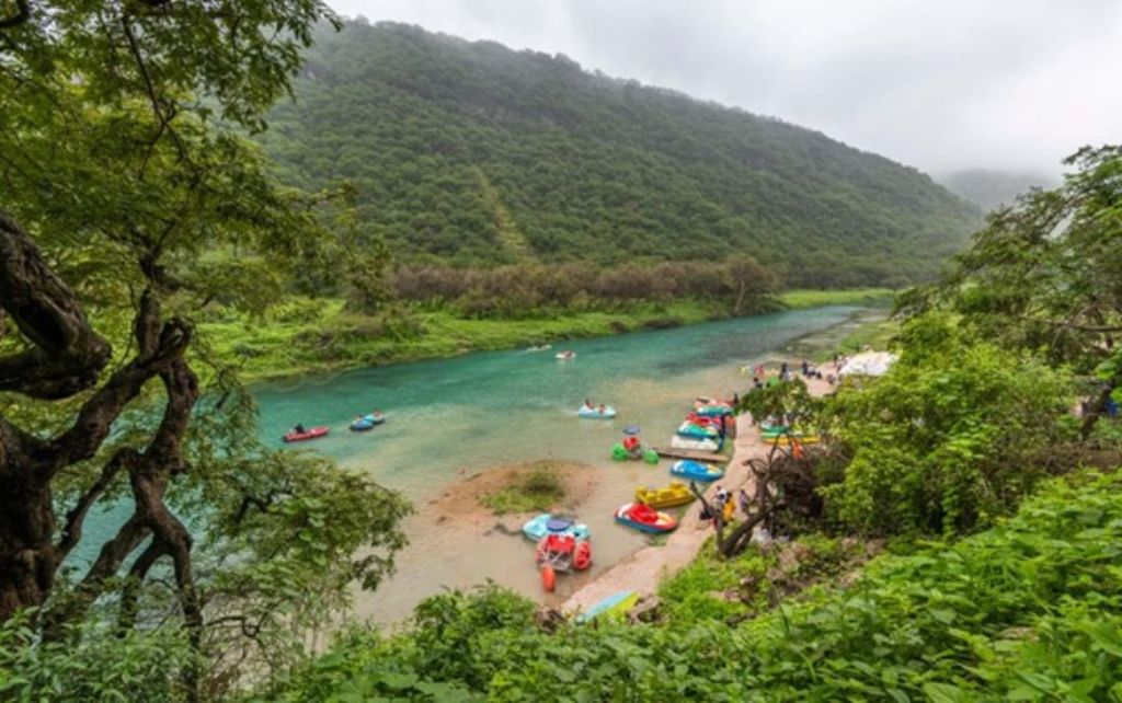 Natural greenery, clear blue water and people boating is a common sight in Salalah